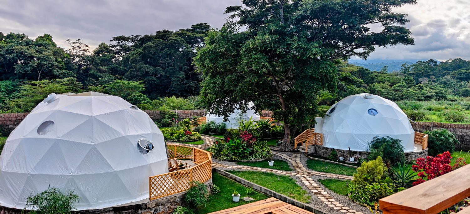 Nekoli domes set in lush garden below Mount Meru