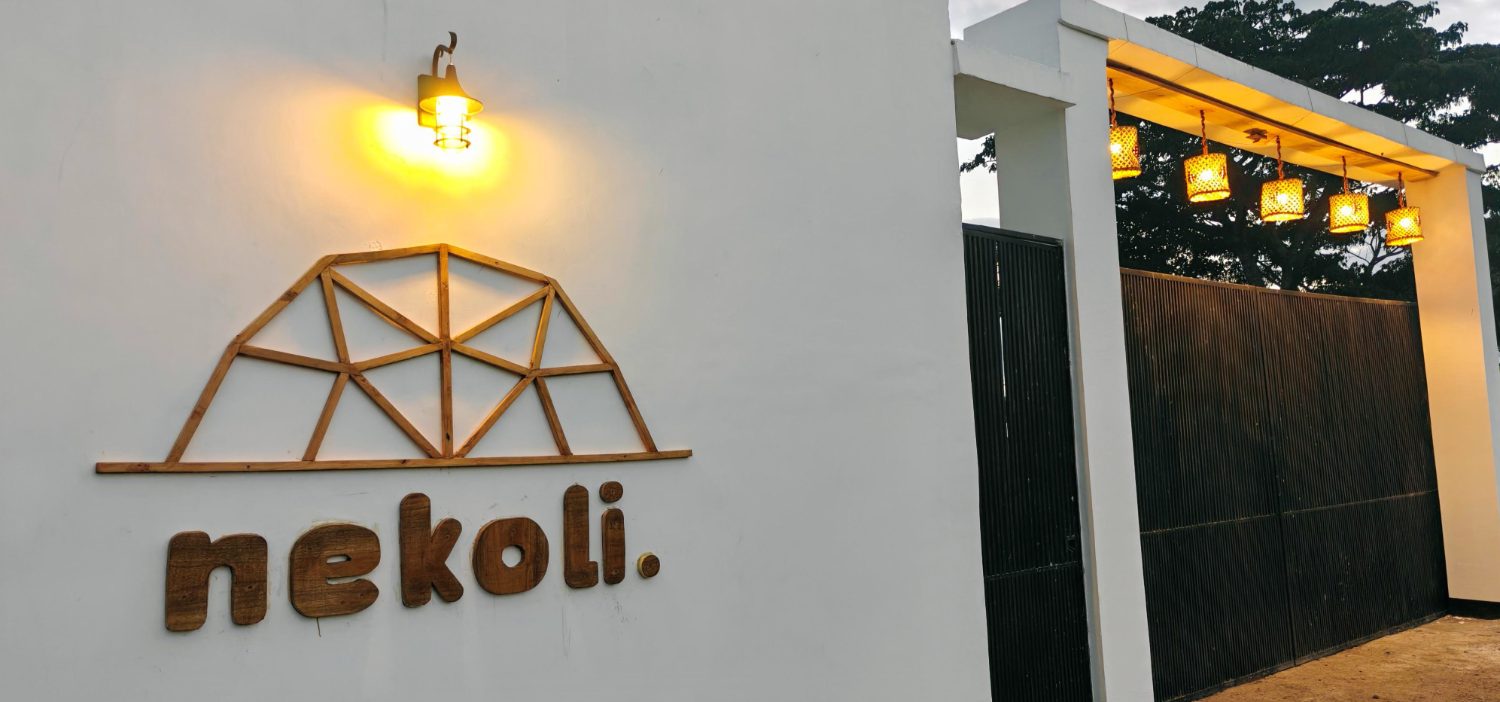 The Nekoli entrance gate at dusk