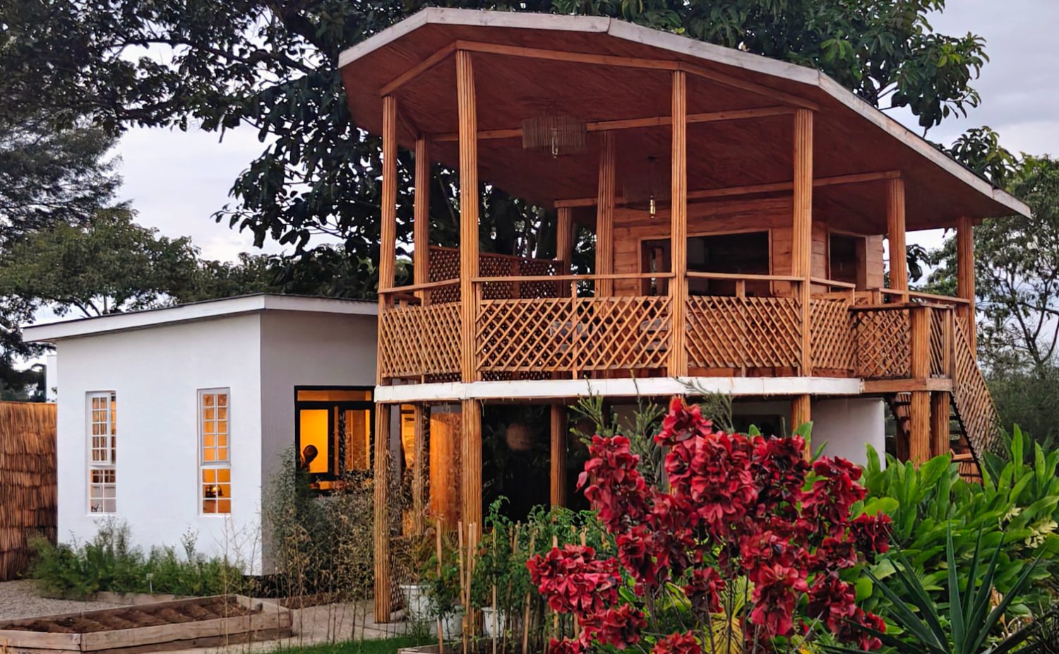 The timber treehouse lounge glowing at dusk